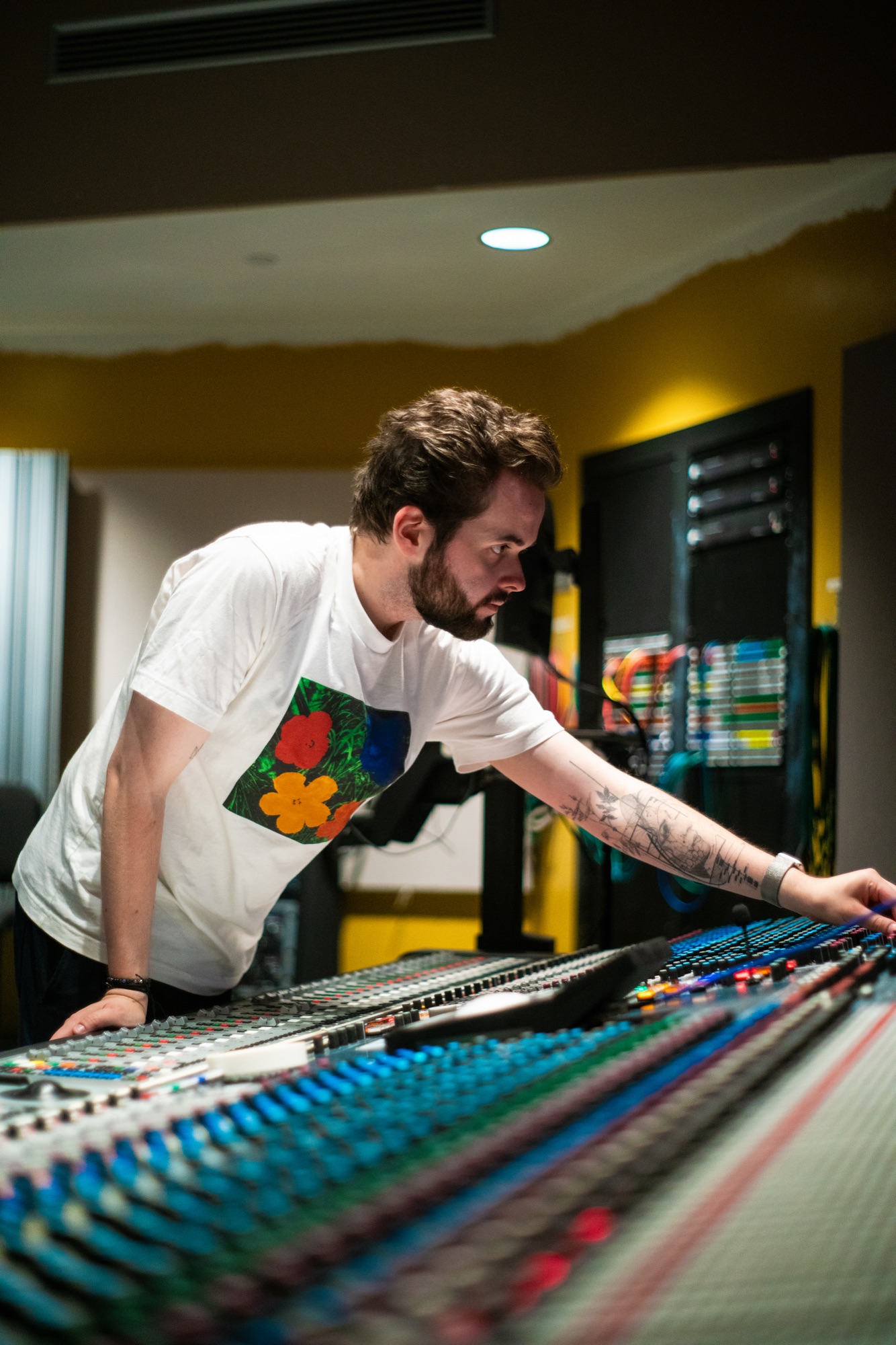 Sebastian Hadl reaching across an analog console