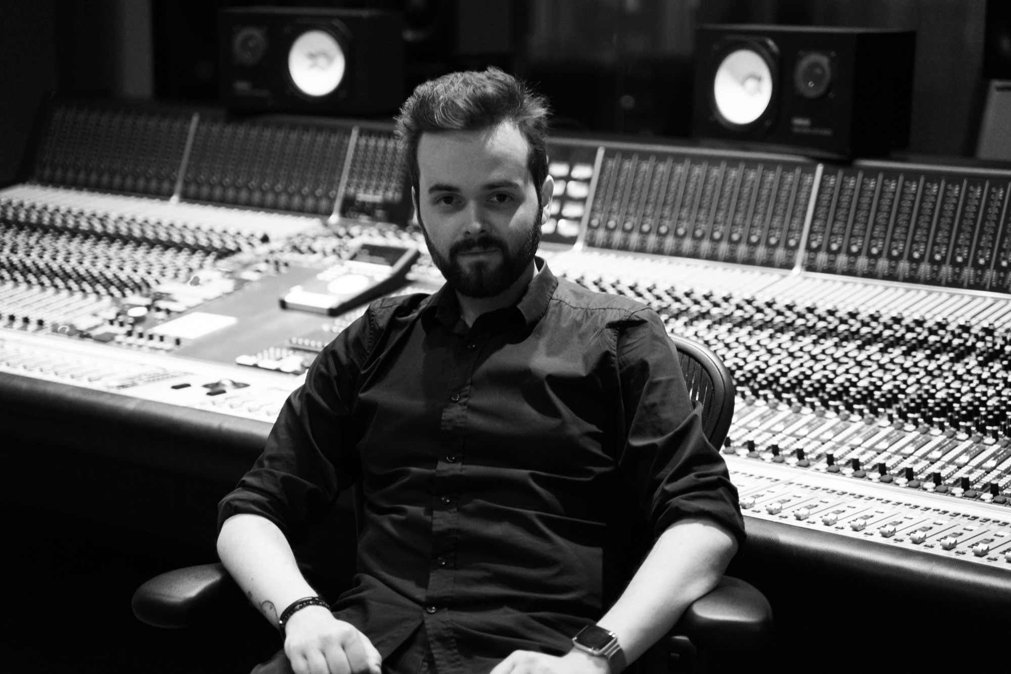 Sebastian seated in front of a mixing console